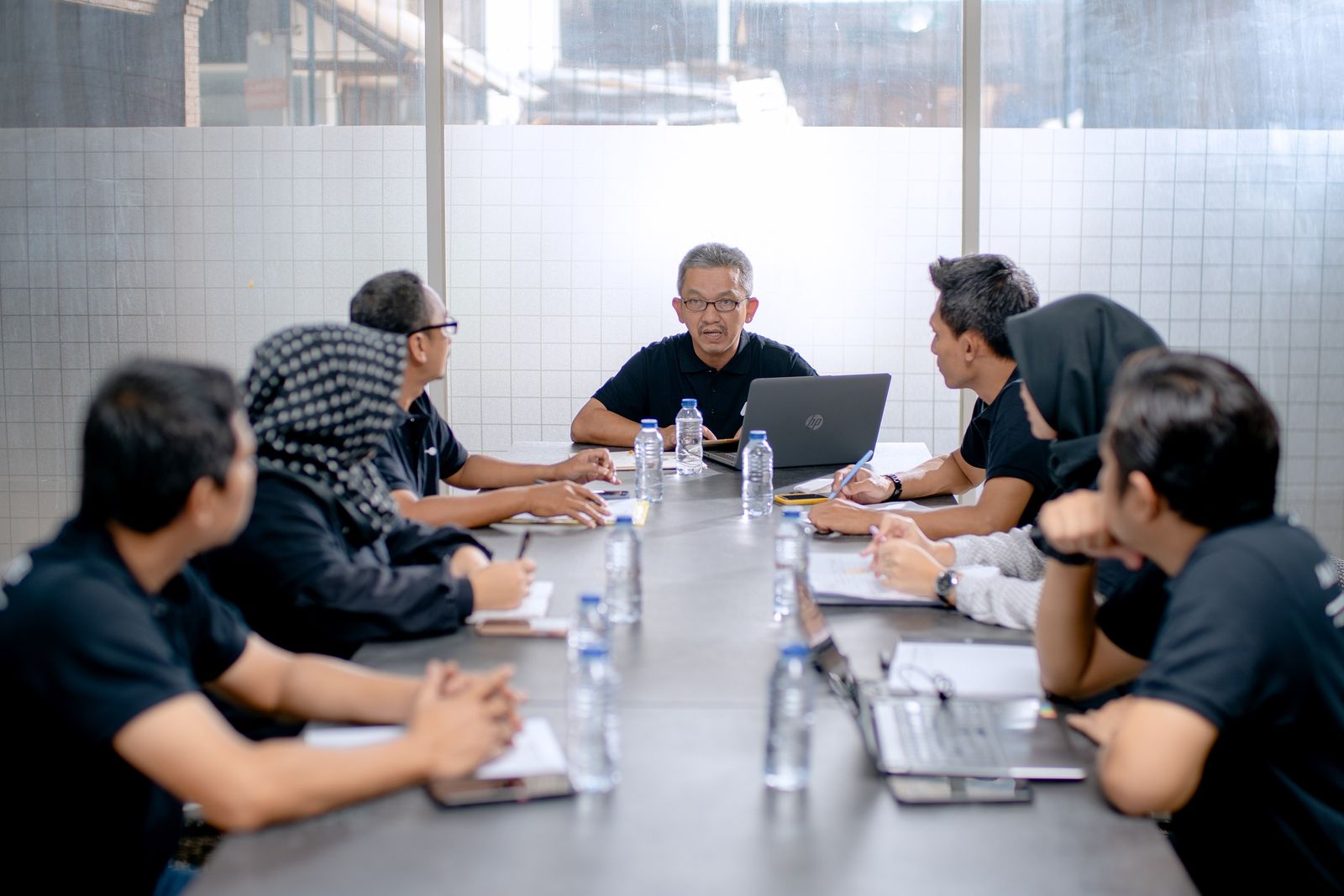 Business advisors meeting privately to discuss a confidential business sale