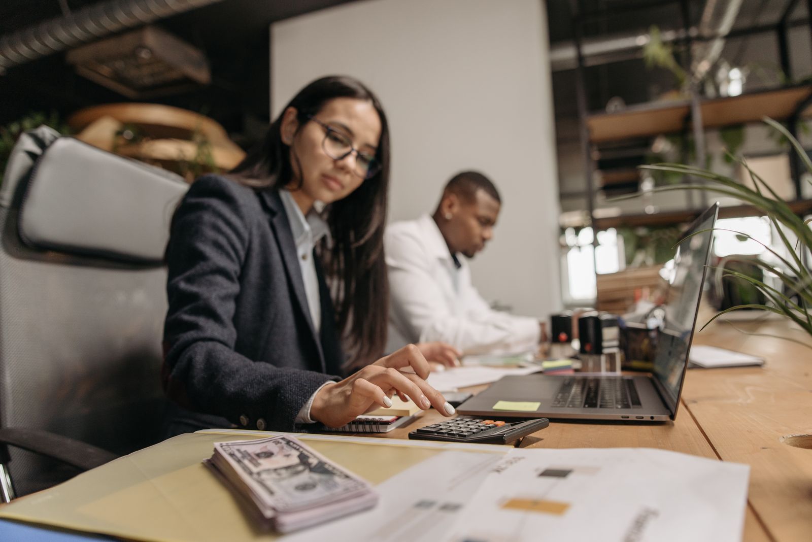Accountant reviewing tax documents and calculations for a business sale