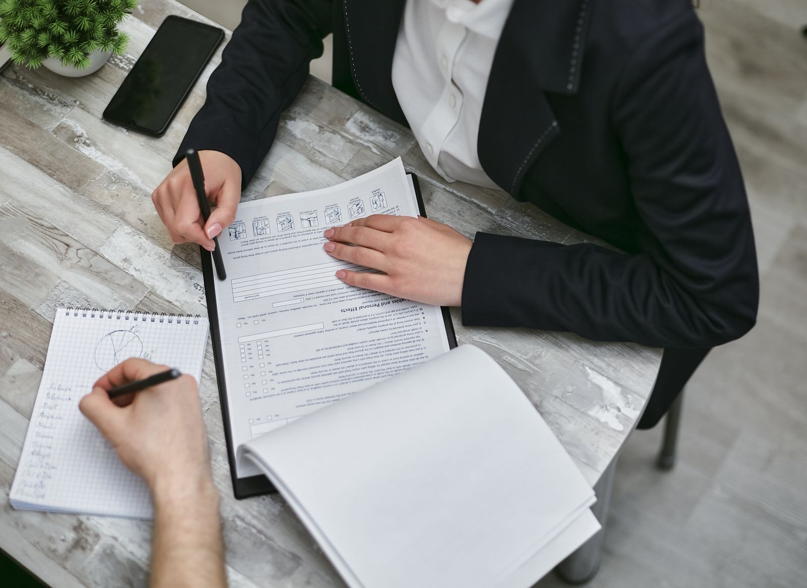 Business owner and advisor reviewing a checklist to prepare a business for sale
